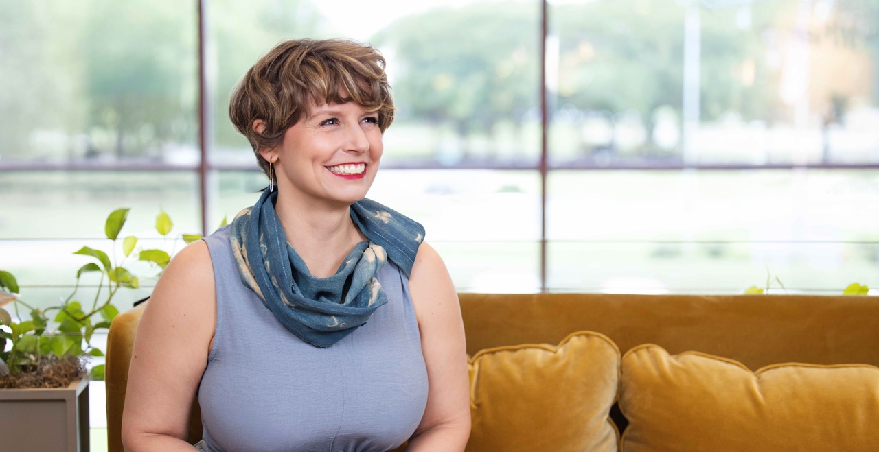 Marie Norton, LPC, seated on a sofa in her Richmond, Virginia counseling office